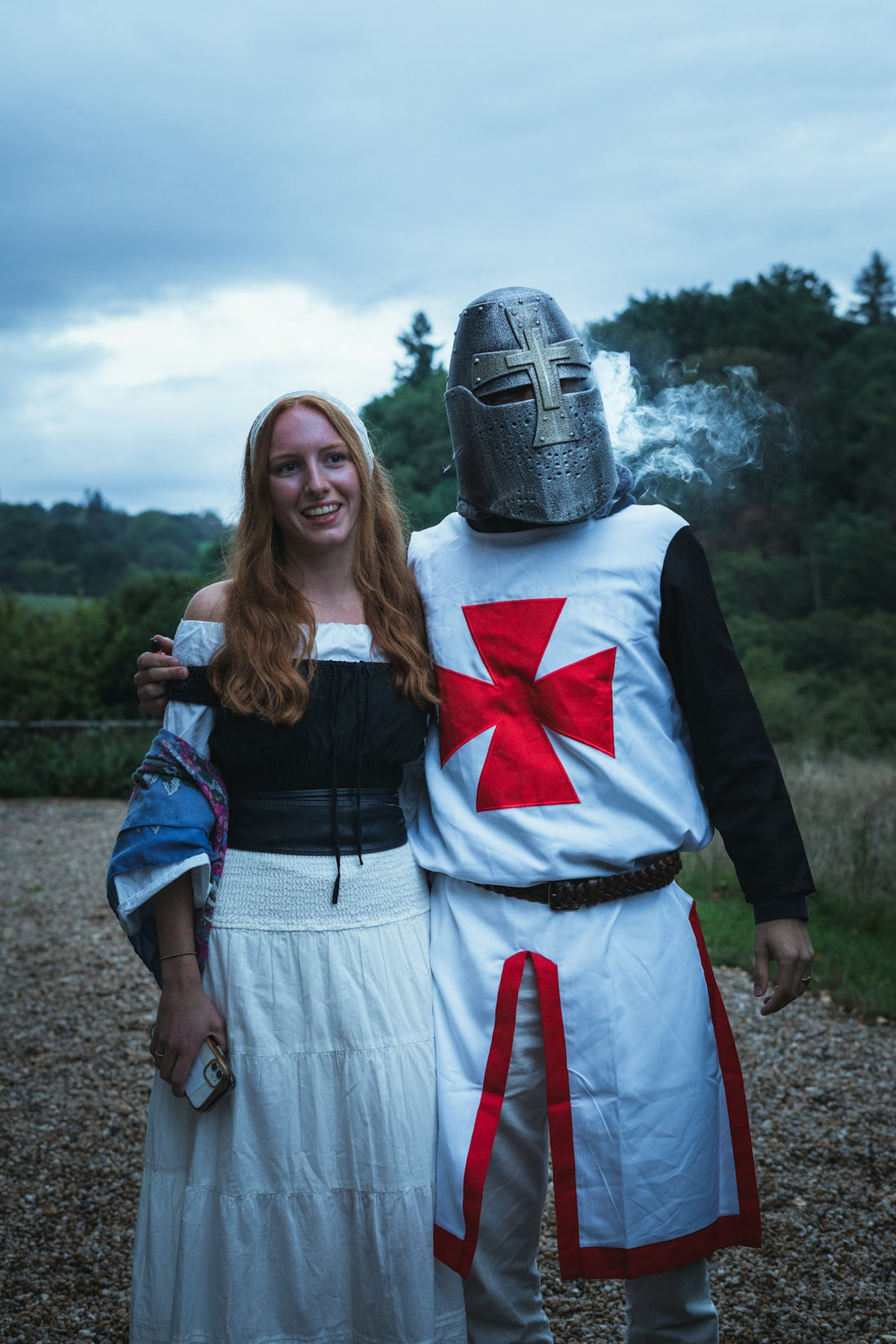 Couple in medieval costumes with a templar knight